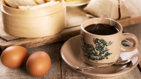 Coffee and eggs - Bring a medium pot of water to a boil. Once boiling, remove from heat and gently add the eggs. Cover and set aside for 7 minutes. Carefully crack each egg into a small bowl, using a spoon to scoop out any remaining egg white. Top with a small splash of dark soy sauce and pinch of ground white pepper.